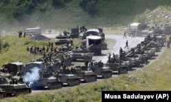 A column of Russian armored vehicles seen moving through South Ossetia to the separatist region's main city, Tskhinvali, on August 9, 2008.