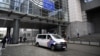 This photograph taken on May 29, 2024 shows a police van in front of the European Parliament building, where searches are conducted as part of a Belgian probe into suspected Russian interference and corruption in Brussels.