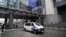 This photograph taken on May 29, 2024 shows a police van in front of the European Parliament building, where searches are conducted as part of a Belgian probe into suspected Russian interference and corruption in Brussels.