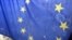 Bosnians pass under a European Union flag in central Sarajevo November 21, 2005. The European Union will start negotiations setting Bosnia on the road to possible EU membership on November 25, the Balkan country's Statehood day, a European Commission offi