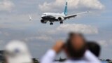 U.K. -- Visitors watch as a Boeing 737 Max lands after an air display during the Farnborough Airshow, south west of London, July 16, 2018