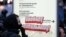 RUSSIA – A protester is seen at an outdoor lightbox map with a "Free Navalny!" message attached to it during an unsanctioned rally by supporters of opposition activist Navalny in central Moscow, April 21, 2021