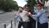 KAZAKHSTAN -- Law enforcement officers detain a man during an opposition rally held by critics of Kazakh President Kassym-Jomart Tokayev, who protest over his election in Almaty, Kazakhstan June 12, 2019