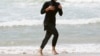 Australia -- Twenty-year-old trainee volunteer surf life saver Mecca Laalaa runs along North Cronulla Beach in Sydney during her Bronze medallion competency test January 13, 2007.
