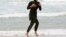 Australia -- Twenty-year-old trainee volunteer surf life saver Mecca Laalaa runs along North Cronulla Beach in Sydney during her Bronze medallion competency test January 13, 2007.