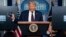 US -- President Donald Trump holds a mask as he speaks during a news conference at the White House, Tuesday, July 21, 2020, in Washington. (AP Photo/Evan Vucci)