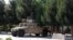 AFGHANISTAN -- Afghan security forces stand guard on a Humvee vehicle along a roadside in Kunduz, June 22, 2021
