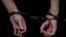 A person in handcuffs at Moscow's Basmanny District Court