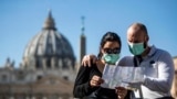 ITALY -- Tourists wearing protective face masks visit St. Peter's Square, Vatican City, 24 February 2020.