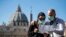 ITALY -- Tourists wearing protective face masks visit St. Peter's Square, Vatican City, 24 February 2020.