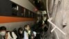 People walk next to a train which derailed in a tunnel north of Hualien, Taiwan April 2, 2021