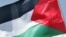 Palestine - A freed Palestinian woman prisoner flashes the V for 'victory' sign and waves her national flag in Ramallah, 20Jul2007
