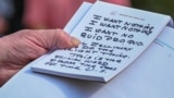 U.S. -- U.S. President Donald Trump holds what appears to be a prepared statement and handwritten notes after watching testimony by U.S. Ambassador to the European Union Gordon Sondland as he speaks to reporters prior to departing for travel to Austin, Te