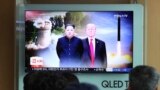 People watch a TV screen showing file footage of U.S. President Donald Trump, right, and North Korean leader Kim Jong Un during a news program at Seoul Railway Station in Seoul, South Korea, Monday, June 11, 2018.
