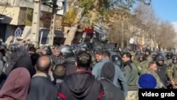 Протестующие и силовики во время протестов в городе Керманшах на западе Ирана, 30 декабря 2025 года