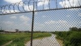 Barbed razor wire above the Rio Grande is pictured from the Mexican side of the Brownsville-Matamoros International Bridge
