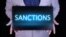 GENERIC – "SANCTIONS" text, word written in neon letters on a black laptop, in front of a businessman in a gray suit
