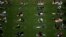 U.S. -- People are seen practising social distancing in white circles in Domino Park, during the Covid-19 pandemic on May 17, 2020 the in Brooklyn borough of New York City. (Photo by Johannes EISELE / AFP)
