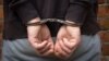 Criminal in handcuffs arrested for crimes. Close-up of a criminal hand in handcuffs