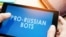 GENERIC – Man holding tablet with words pro-russian bots. Russian internet propaganda concept.