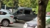 A van with Belarusian security officers pictured outside RFE/RL's offices in Minsk on July 16. 