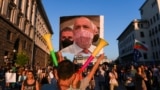 BULGARIA -- A protestor holds a collage mocking the Bulgarian Prime minister wearing a protective mask made of a 500 euros bill during an anti-government protest in Sofia, July 29, 2020