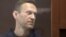 RUSSIA -- Aleksei Navalny, accused of slandering a Russian World War Two veteran, stands inside a defendant dock during a court hearing in Moscow, Russia February 5, 2021