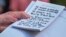 U.S. -- U.S. President Donald Trump holds what appears to be a prepared statement and handwritten notes after watching testimony by U.S. Ambassador to the European Union Gordon Sondland as he speaks to reporters prior to departing for travel to Austin, Te