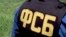 RUSSIA - A Russian Federal Security Service officer looks at a derailed train 150 km (90 miles) south of Moscow, Sunday, June 12, 2005.