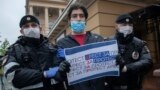 RUSSIA -- Police detain a protester after holding a one-man protest in violation of the city's coronavirus restrictions, in front of the city's police headquarters in Moscow, May 29, 2020