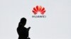 (FILES) In this file photo taken on March 6, 2019 a staff member of Huawei uses her mobile phone at the Huawei Digital Transformation Showcase in Shenzhen, China's Guangdong province. - US internet giant Google, whose Android mobile operating system power