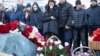 RUSSIA -- People gather at a makeshift memorial to victims of the March 25, 2018 fire at the Zimnyaya Vishnya in Kemerovo, March 25, 2019