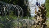 Lithuania toughens Belarus border with razor wire to bar migrants