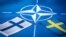 GENERIC – Flags of Sweden and Finland against the background of the symbol of NATO