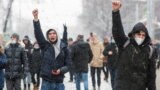 Moscow, Russia - Protestors raise their fists during a rally in support of jailed Russian opposition leader Alexei Navalny
