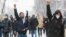 Moscow, Russia - Protestors raise their fists during a rally in support of jailed Russian opposition leader Alexei Navalny