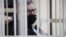  BELARUS -- Viktar Babaryka, former head of Belgazprombank and challenger in the 2020 presidential election, who was jailed on corruption charges, sits inside a defendants' cage before a court hearing in Minsk, February 17, 2021
