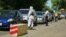 Kyrgyzstan - Bishkek - life in the city after quarantine -  roads - people - street - parks   a man in protective uniform checks the driver on the road to Bishkek12 May 2020