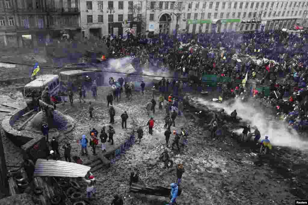 People gather at the the site of clashes between pro-European protesters and riot police in Kyiv on&nbsp;January 23.