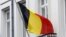 Belgium -- European Union and Belgian flags fly at half mast outside an official government building in Brussels, 16Mar2012