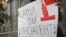 Russia -- A journalist holds a placard which reads "Foreign agents yourself" near the headquarters of Federal Security Service in Moscow