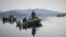 RUSSIA -- Rescuers work at the site where the Mi-8 helicopter crash-landed into Kuril Lake, in Kamchatka region, August 17, 2021