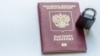 GENERIC – Russian passport in chains locked to castle. Symbol of anti-Russian sanctions.