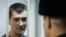 Russia - Oleg Navalny, brother of an anti-Kremlin opposition leader, looks on from the defendant's cage as he attends the verdict announcement of his fraud trial at a court in Moscow, December 30, 2014