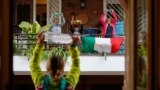 ITALY --Personal trainer Antonietta Orsini carries out an exercise class for her neighbours from her balcony while Italians cannot leave their homes due to the coronavirus disease (COVID-19) outbreak, in Rome, Italy, March 18, 2020. 