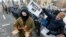 UKRAINE -- Activists and supporters of different Ukrainian nationalists parties hold placard reading ?Russian world? during their action to block access for Russian citizens living in Ukraine to the election committee and polling station at the Russian em