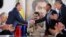 VENEZUELA -- Head of Russian state oil firm Rosneft Igor Sechin ( L) shakes hands with Venezuelan Oil Minister and President of the Venezuelan state oil company PDVSA Manuel Quevedo, in front of Venezuelan President Nicolas Maduro, in Maiquetia, December 