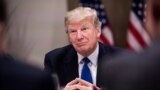SWITZERLAND -- US President Donald Trump listens to a speaker during a working dinner with European business leaders during the World Economic Forum (WEF) annual meeting in Davos, eastern Switzerland, on January 25, 2018
