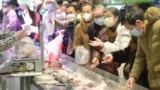 Customers wearing face masks shop inside a supermarket following an outbreak of the novel coronavirus in Wuhan, Hubei province, China February 10, 2020. China Daily via REUTERS ATTENTION EDITORS - THIS IMAGE WAS PROVIDED BY A THIRD PARTY. CHINA OUT. - RC
