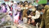 Customers wearing face masks shop inside a supermarket following an outbreak of the novel coronavirus in Wuhan, Hubei province, China February 10, 2020. China Daily via REUTERS ATTENTION EDITORS - THIS IMAGE WAS PROVIDED BY A THIRD PARTY. CHINA OUT. - RC